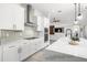 Modern kitchen features white shaker cabinets, stainless steel appliances, and herringbone backsplash at 9028 Ivy Stark Blvd, Wesley Chapel, FL 33545