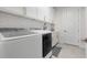 Bright laundry room with white cabinets and Samsung appliances at 9028 Ivy Stark Blvd, Wesley Chapel, FL 33545