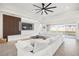 Open living space with white sectional and marble accent wall at 9028 Ivy Stark Blvd, Wesley Chapel, FL 33545