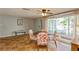 Bright dining area with floral chairs and terracotta tile floors at 9830 Mark Twain Ln, Port Richey, FL 34668