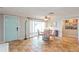 Bright dining area with terracotta tile floor and floral chairs at 9830 Mark Twain Ln, Port Richey, FL 34668