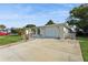 House exterior showcasing a driveway, garage, and well-maintained front yard at 9830 Mark Twain Ln, Port Richey, FL 34668