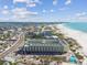 Aerial view of beachfront condo building with ocean and city views at 12000 Gulf Blvd # 212-N, Treasure Island, FL 33706