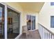 Private balcony with sliding doors and chair at 12000 Gulf Blvd # 212-N, Treasure Island, FL 33706