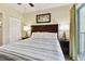 Bright bedroom with a queen-size bed and ceiling fan at 12000 Gulf Blvd # 212-N, Treasure Island, FL 33706