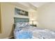 Bedroom with full-size bed, coastal bedding, and nightstand at 12000 Gulf Blvd # 212-N, Treasure Island, FL 33706