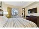 Bedroom with a king-size bed, TV, and balcony view at 12000 Gulf Blvd # 212-N, Treasure Island, FL 33706