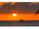 Spectacular sunset view over calm ocean with sailboat at 12000 Gulf Blvd # 212-N, Treasure Island, FL 33706