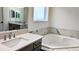 Elegant bathroom featuring a soaking tub and dual vanities at 19314 Eagle Creek Ln, Tampa, FL 33647