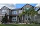 Two-story house with gray siding, landscaping, and palm trees at 19314 Eagle Creek Ln, Tampa, FL 33647