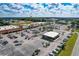 Aerial view of shopping center with ample parking and various stores at 36522 Well Hill Way, Zephyrhills, FL 33541