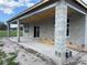 Covered patio under construction has concrete flooring and view of green backyard at 413 Shannon Estates Ct, Plant City, FL 33563