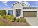 House exterior featuring a two-car garage and manicured landscaping at 8321 Sky Eagle Dr, Tampa, FL 33635