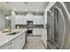 Sleek kitchen with stainless steel refrigerator and white cabinetry at 8321 Sky Eagle Dr, Tampa, FL 33635