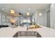 Kitchen island with sink, modern lighting and seating for four at 8321 Sky Eagle Dr, Tampa, FL 33635