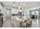 Large kitchen island with seating, white cabinets and stainless steel appliances at 8321 Sky Eagle Dr, Tampa, FL 33635