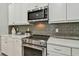 Stainless steel appliances and gray backsplash in this modern kitchen at 8321 Sky Eagle Dr, Tampa, FL 33635