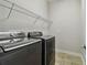 Laundry room with washer, dryer, and shelving at 8321 Sky Eagle Dr, Tampa, FL 33635