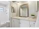 Bathroom featuring white cabinets, neutral countertops, framed mirror, and walk-in shower at 14160 82Nd Ter, Seminole, FL 33776