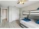 Bedroom features a bunk bed with light-colored flooring and a closet with folding doors at 14160 82Nd Ter, Seminole, FL 33776