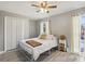 Bright bedroom featuring neutral walls, a ceiling fan, and a window with sheer curtains at 14160 82Nd Ter, Seminole, FL 33776