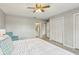 Bright bedroom featuring neutral walls, white closet doors, ceiling fan, and ensuite bathroom at 14160 82Nd Ter, Seminole, FL 33776