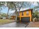 Angled shot of this yellow home showing the attached two car garage and driveway at 14160 82Nd Ter, Seminole, FL 33776