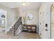 Open foyer with stairs, console table with decorative mirror, and stylish light-colored wood flooring at 14160 82Nd Ter, Seminole, FL 33776