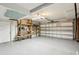 Spacious garage with shelving for storage and large garage door at 14160 82Nd Ter, Seminole, FL 33776