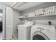 Laundry room including a washer, dryer, and shelving with towels for storage at 14160 82Nd Ter, Seminole, FL 33776