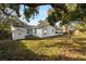 House exterior view with a large backyard and shed at 14915 Gentilly Pl, Tampa, FL 33624