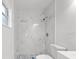 Updated bathroom with marble-look shower and toilet at 14915 Gentilly Pl, Tampa, FL 33624