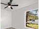 Bright bedroom with ceiling fan and large window at 14915 Gentilly Pl, Tampa, FL 33624