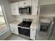 Bright kitchen with stainless steel appliances and white shaker cabinets at 14915 Gentilly Pl, Tampa, FL 33624