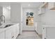 Bright kitchen with white cabinets, quartz countertops, and stainless steel appliances at 14915 Gentilly Pl, Tampa, FL 33624