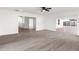 Bright living room with wood-look floors and sliding glass doors at 14915 Gentilly Pl, Tampa, FL 33624