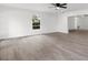 Spacious living room featuring light walls and wood-look floors at 14915 Gentilly Pl, Tampa, FL 33624