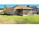 Backyard view featuring a screened-in porch and well-maintained lawn; ideal for outdoor activities at 30923 Burleigh Dr, Wesley Chapel, FL 33543