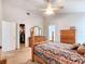 Main bedroom with king bed, walk-in closet, adjacent ensuite bathroom, and neutral colored walls at 30923 Burleigh Dr, Wesley Chapel, FL 33543