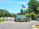 Gated community entrance featuring an American flag and manicured landscaping at 30923 Burleigh Dr, Wesley Chapel, FL 33543