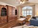 Inviting living room with wood floors, built-in shelving, large arched window and comfortable seating at 30923 Burleigh Dr, Wesley Chapel, FL 33543