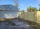 Detached garage with new white door and new wooden fence at 920 Hull S St, Gulfport, FL 33707