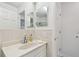 Bright bathroom with single sink vanity and mirror at 5 Gateshead Dr # 203, Dunedin, FL 34698