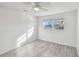 Bright bedroom featuring wood-look floors and a ceiling fan at 5 Gateshead Dr # 203, Dunedin, FL 34698