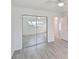 Mirrored closet doors and wood-look floors in this bedroom at 5 Gateshead Dr # 203, Dunedin, FL 34698