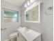 Clean bathroom, white vanity, and marble shower at 106 S Nimbus Ave, Clearwater, FL 33765