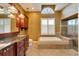 Luxurious bathroom with a large soaking tub, glass shower, and elegant fixtures at 12006 Stone Crossing Circle, Tampa, FL 33635