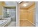 Bathroom featuring a glass-enclosed shower and an open closet at 12006 Stone Crossing Circle, Tampa, FL 33635