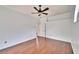 Large empty bedroom with wood flooring, ceiling fan and neutral color scheme at 12006 Stone Crossing Circle, Tampa, FL 33635