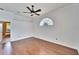 Bright, empty bedroom featuring wood floors, a ceiling fan and a unique window at 12006 Stone Crossing Circle, Tampa, FL 33635